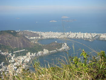 High angle view of sea and buildings against sky