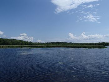Scenic view of lake against blue sky