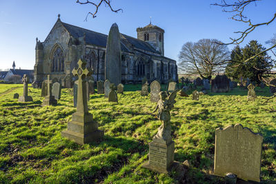Panoramic view of cemetery and buildings against sky