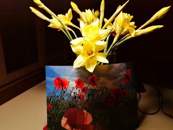 Close-up of yellow flower vase on table