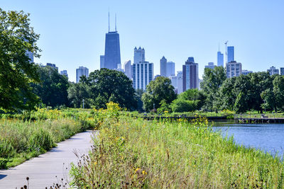 Scenic view of trees and buildings against clear sky