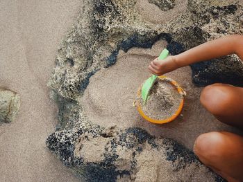 High angle view of child playing on sand
