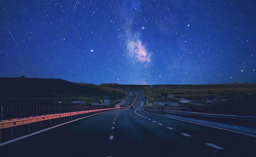 Scenic view of road against sky at night