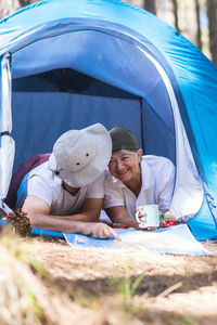 Portrait of woman sitting in tent