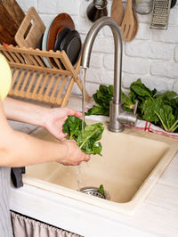 Midsection of man preparing food in kitchen