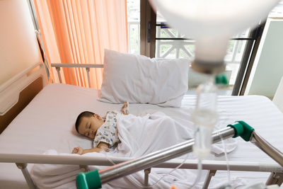 High angle view of baby boy lying on bed in hospital