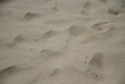 High angle view of footprints on sand at beach