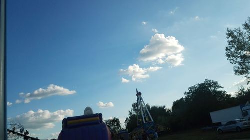 Low angle view of trees against blue sky