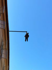 Low angle view of rope against clear blue sky