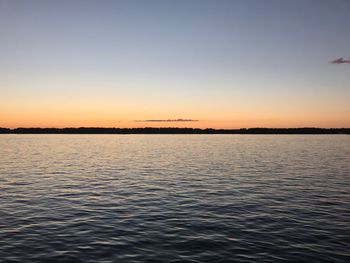 Scenic view of sea against clear sky during sunset