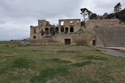 Old ruin building against cloudy sky