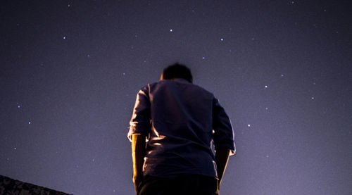 Low angle view of people standing in the dark