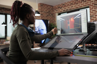 Young woman working on computer in office