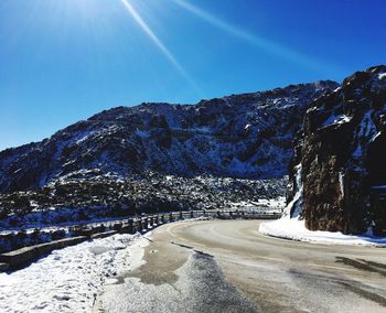 Scenic view of snowcapped mountain against blue sky