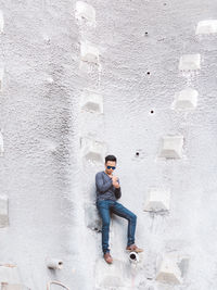 Full length of woman standing on wall