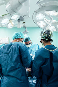 Surgeons working in operating room