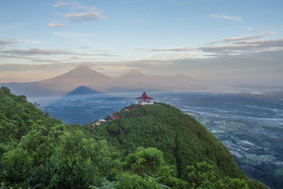 Scenic view of mountain against cloudy sky