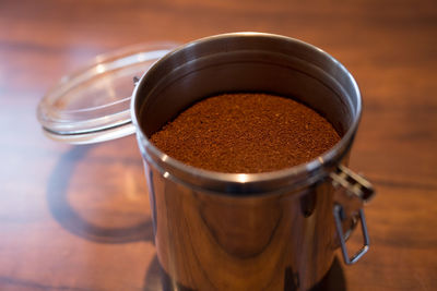 Close-up of ground coffee in jar on table