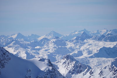 Scenic view of snow covered mountains against sky