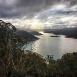 Scenic view of sea and mountains against sky