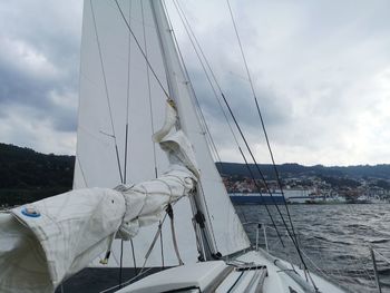 Sailboat sailing on sea against sky