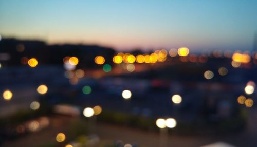 Defocused image of illuminated city at night