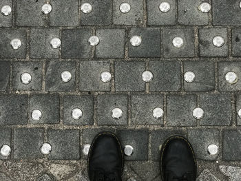 Low section of man standing on footpath