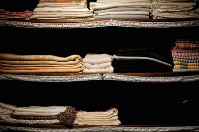Close-up of folded clothes on shelves