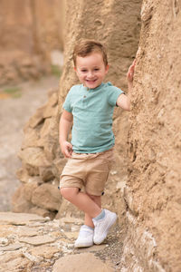 Portrait of boy standing on rock