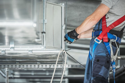 Midsection of worker working in factory