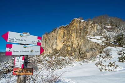 Scenic view of snowcapped mountains against clear blue sky