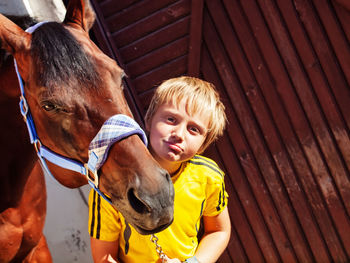 Portrait of happy boy in stable