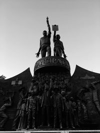 Low angle view of statue against sky