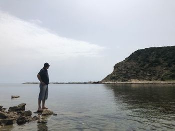 Man looking at sea against sky