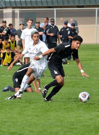 Group of people playing soccer on field