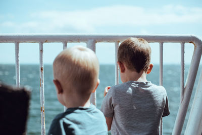Two young boys enjoying the view from the ferry to helsingborg. 3 and 4 years old. 
