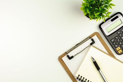 High angle view of books on table against white background