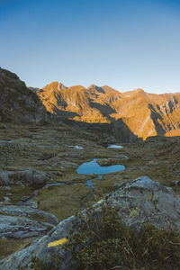 Scenic view of mountains against clear blue sky