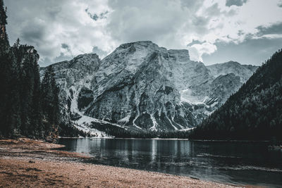 Scenic view of lake by mountains against sky