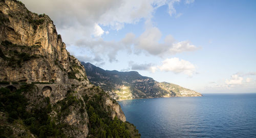 Scenic view of sea and mountains against sky