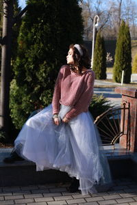 Woman standing on retaining wall at park