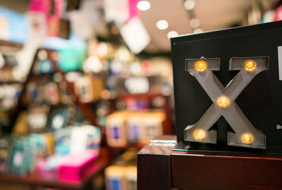 Close-up of illuminated lamp on table