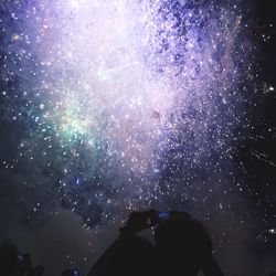 Low angle view of firework display at night