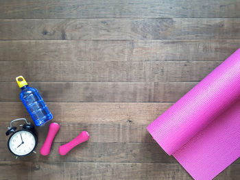 High angle view of pink bottles on table