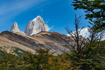 Low angle view of mountain against blue sky