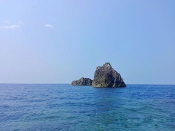 Scenic view of sea against blue sky