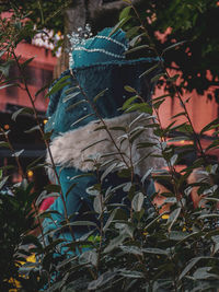 Low angle view of statue against trees