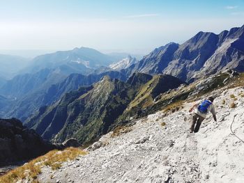 Panoramic view of people walking on mountain against sky