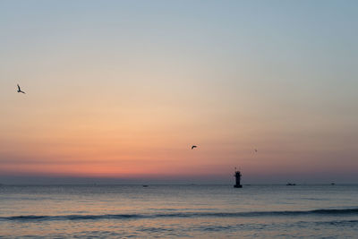 Scenic view of sea against sky at sunset