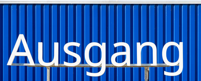 Close-up of text on blue wall